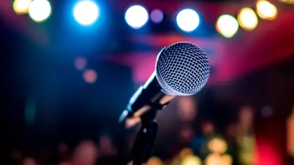 Microphone on stage against a background of auditorium.